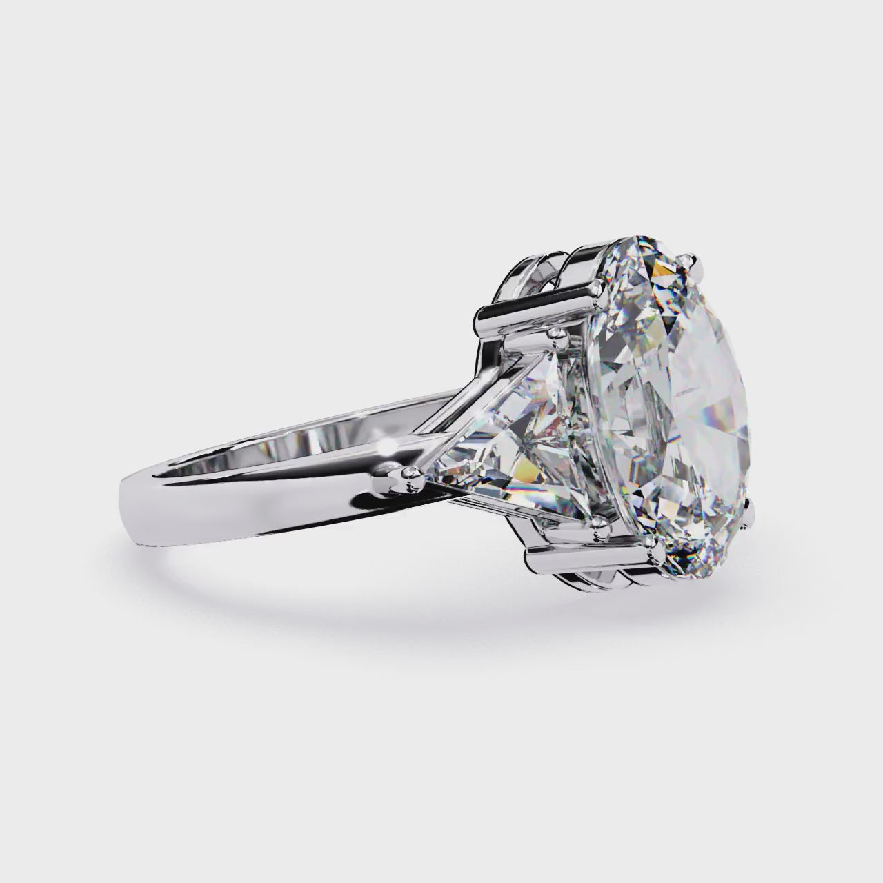 The Stella Oval With Triangle Three Stone Engagement Ring