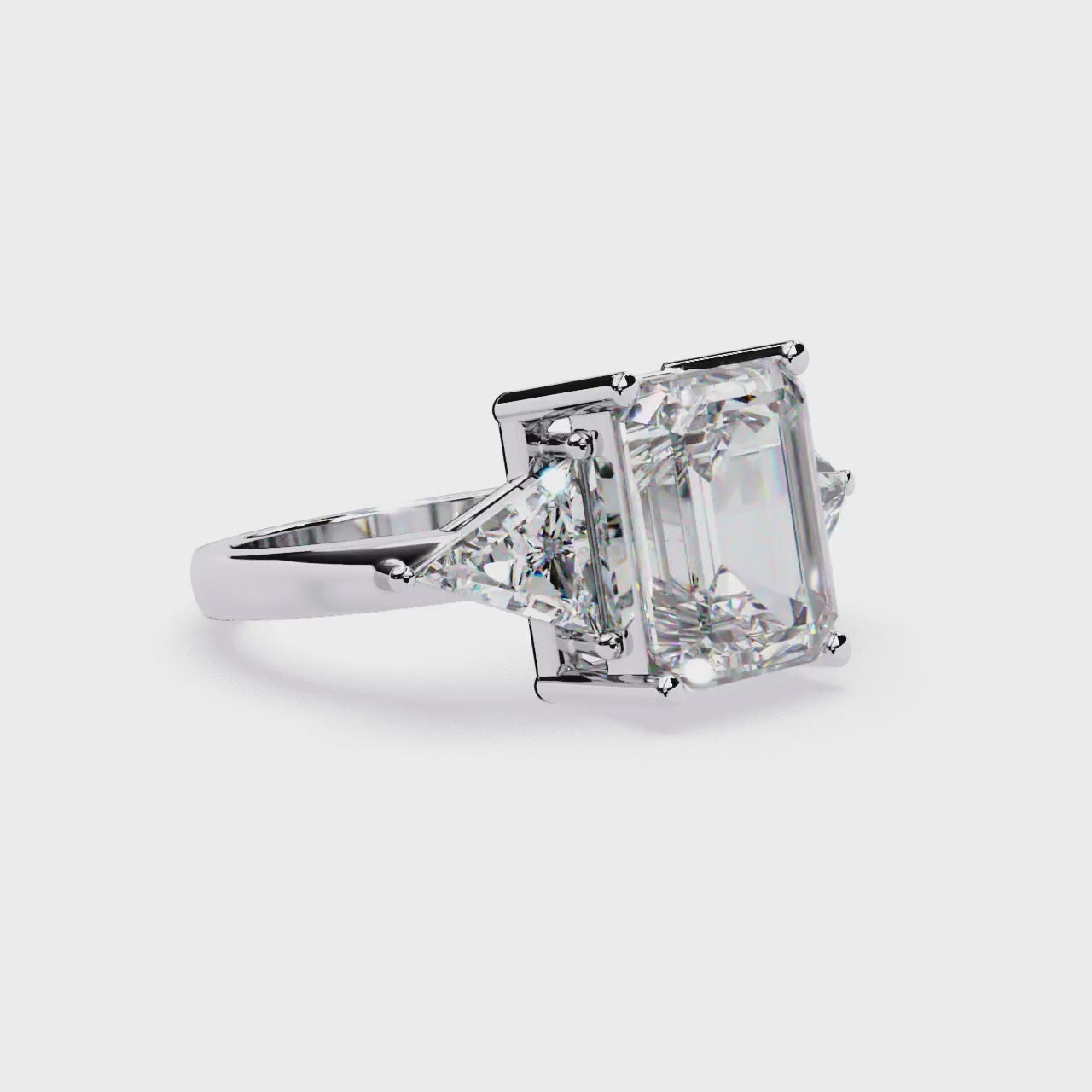 The Stella Emerald With Triangle Three Stone Engagement Ring